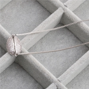 Elegant copper necklace with a shell pendant set with sparkling zircon stones in a gift box