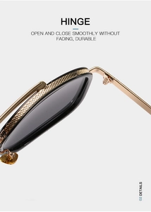 Detail of durable gold metal hinge with knurled pattern on trendy oversized sunglasses