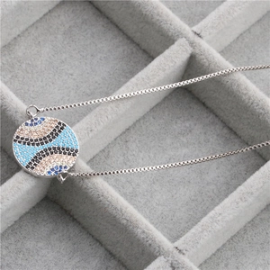 Silver Evil Eye pendant necklace with blue and black zircon stones on box chain