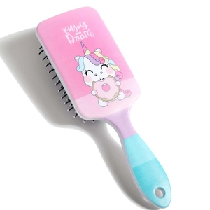 Detail of pink and blue gradient hairbrush featuring a cute unicorn and donut pattern