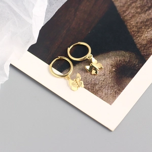 Detailed view of 925 sterling silver hoop earrings with gold butterfly charms on a card