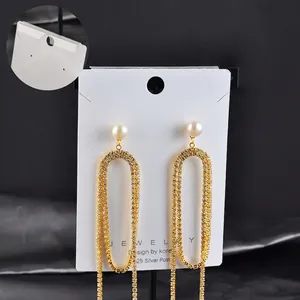 Elegant gold-tone long fringe earrings with pearls and 925 silver needles on card