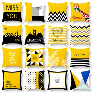 Grid of 16 square yellow and black throw pillow covers with decorative English phrases