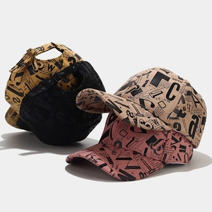 Graffiti newspaper print baseball caps in yellow, black, beige, and pink colors