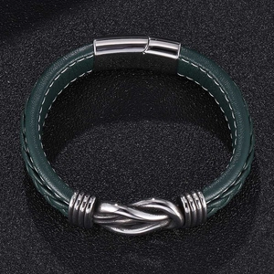 Detail of dark green braided leather bracelet with silver knot and magnetic clasp