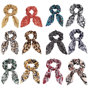 Set of 12 leopard and floral print bunny ear scrunchies in various vibrant patterns