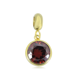 Detail of 18k gold stainless steel pendant with round dark red gemstone on white background
