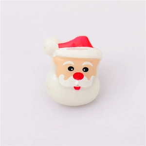 Detailed macro view of a cartoon Santa Claus resin charm for Christmas glowing rings