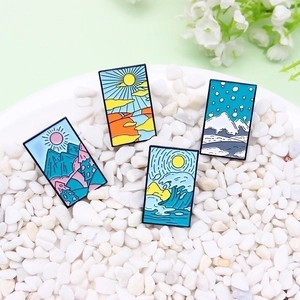 Four-piece seasonal landscape enamel pins featuring mountains, sea, and sunset scenery