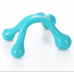 Detail of teal plastic 4-point manual massager with ergonomic handle for body muscle relief