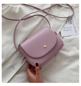 Detail of light purple PU leather crossbody bag with metal snap and knot strap