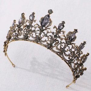 Close-up of vintage baroque crown with bronze frame and dark grey crystals