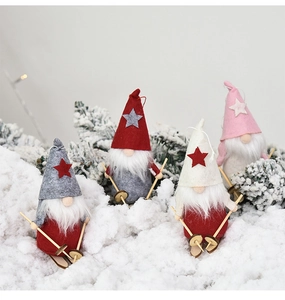 Detail of four Christmas gnomes with wooden skis and hats on a snowy forest background