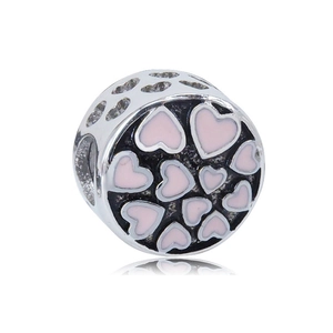 Macro view of silver stainless steel charm with pink enamel hearts and hollow structure