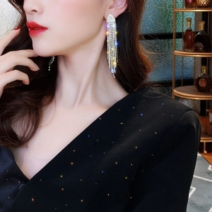 Elegant silver long rhinestone tassel dangle earrings worn by a model in a side view