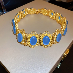 Vintage gold necklace with oval blue gemstones and intricate hollow geometric heart patterns