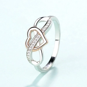 Infinity heart ring with rose gold plating and crystal stones on a clean background