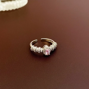 Detail of pink oval zircon ring with micro-pave crystals on a leather background