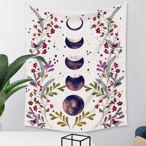 Detail of bohemian moon phase tapestry with floral botanical patterns and butterfly prints