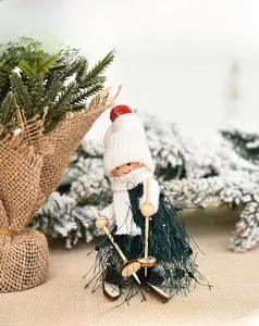 Detail of wooden ski doll ornament with green faux fur and white knitted scarf decoration