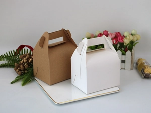 Detail of kraft and white paper gift boxes with handles on a white tray with flowers