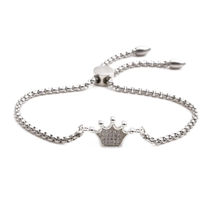 Adjustable stainless steel crown bracelet with micro-pave crystals on white background
