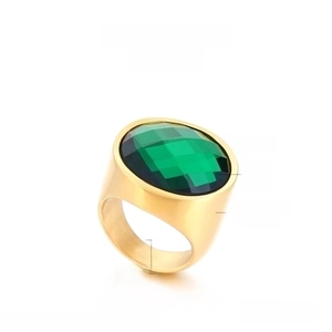 Detail showing 22mm gold stainless steel ring with a faceted emerald green glass stone