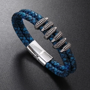 Detail of blue and black woven leather bracelet for men with silver magnetic metal clasp