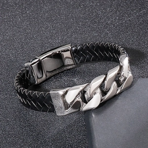 Detail of black braided leather combined with polished silver stainless steel Cuban chain