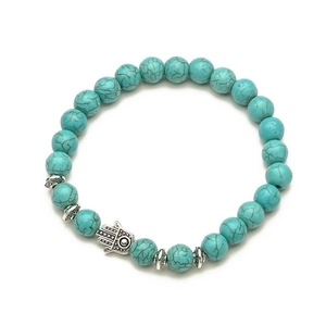 Detail of turquoise beaded bracelet with Hamsa Hand charm and vintage metal spacers