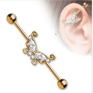 Detail of gold butterfly industrial barbell featuring marquise and round cut zircon stones
