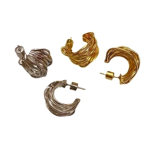 Intertwined gold and silver C-shaped twisted earrings with openwork textured design