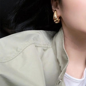 Elegant gold spiral drop earrings with 925 silver needle, shown on model for a trendy look