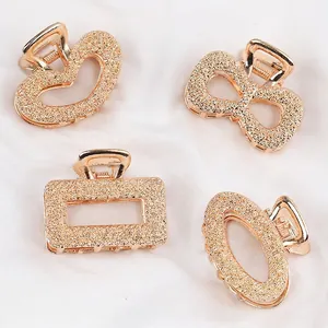 Minimalist 4-piece champagne gold metal hair claw clip set with textured geometric shapes