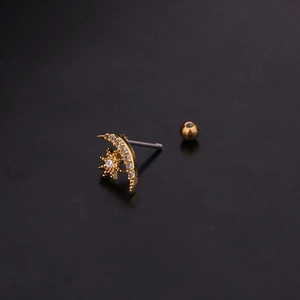Detailed view of gold star and moon screw-back studs with sparkling zircon stones