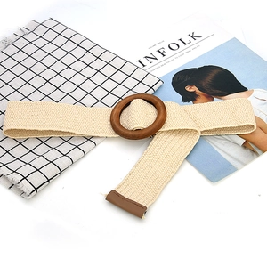 Woven elastic belt with round wooden buckle and brown leather tip on check fabric