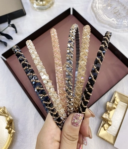 Close-up of handmade crystal beaded headbands in various colors including pink and black