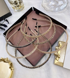 Close-up of sparkling crystal-encrusted thin headbands in various elegant colors