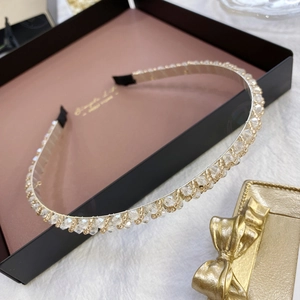 Detail of thin champagne gold metal headband with sparkling crystals and beads