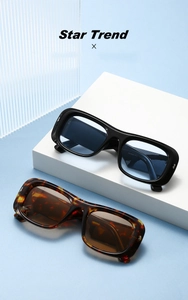 Detail of ZN3932 rectangular sunglasses in black and tortoiseshell on a white stand