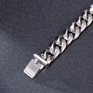 Macro shot of silver snake pattern Cuban link bracelet with polished buckle