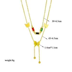 Double-layered gold necklace with butterfly pendant and colorful gemstone accents