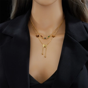 Gold double-layered butterfly necklace with colorful crystals and fringe on a model