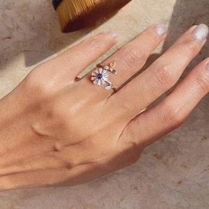 Rotating bee and daisy open ring with purple center stone and white petals