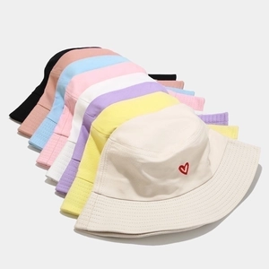 Cotton bucket hat with red heart embroidery shown in multiple pastel colors stack