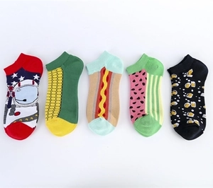 Detailed flat lay of cotton socks featuring astronaut, corn, hot dog, and fruit patterns