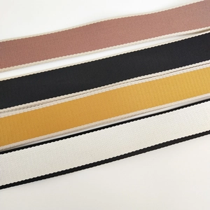 Detailed view of 3.8cm woven canvas bag straps in pink, black, yellow, and white colors