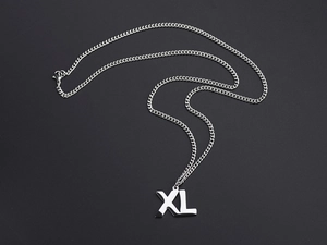 Macro view of XL letter pendant on silver Cuban chain made of polished stainless steel