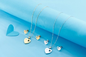 Detail of sweet heart-shaped jewelry set with hollow design and inlaid diamond details