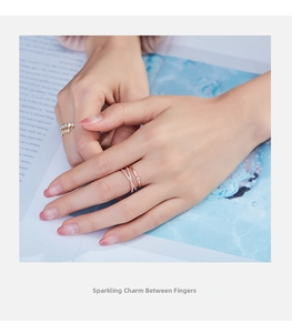 Close-up of double-layer rose gold crisscross rings with white zircon on finger